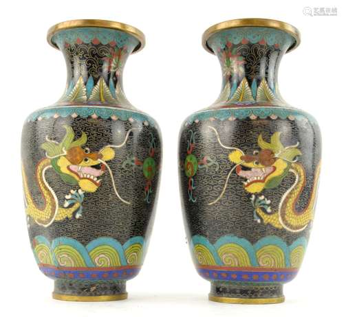 A pair of Chinese cloisonne enamel vases; each one decorated with a dragon on a black ground, 24