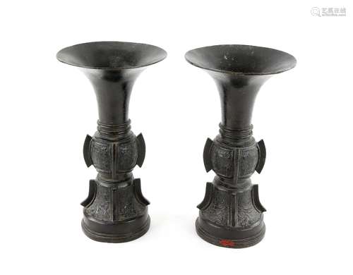 A pair of archaistic bronze or metal alloy vases; each one with trumpet neck and circular base