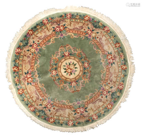 ROUND CHINESE CARPET, TIEN-TSIN MID-20TH CENTURY on green ground, with design of flowers and leaves.