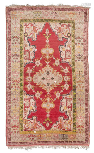 WESTERN ANATOLIAN CARPET, EARLY 20TH CENTURY design of medallion and flowered branches, in the