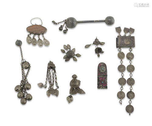 EIGHT NECKLACES IN METAL, MIDDLE EAST EARLY 20TH CENTURY consisting of two rattles, a buckle and