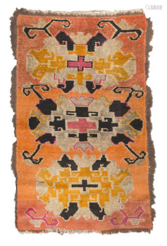 TIBETAN CARPET, 19TH CENTURY triple 'abstract' medallion with crosses and hooks, in the field on