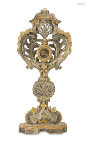 BIG SHRINE IN SILVER-PLATED IS GILDED WOOD, ROME 18TH CENTURY with central relic in glass case.