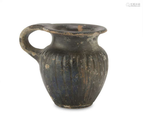 BLACK-GLAZED MINIATURE VASE, 4TH CENTURY B.C. in orange clay, painted shining black. Entire. h.