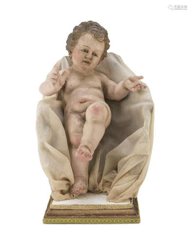 SCULPTURE OF A CHILD, NAPLES 19TH CENTURY polychrome lacquered, with glass eyes. Complete of seat in