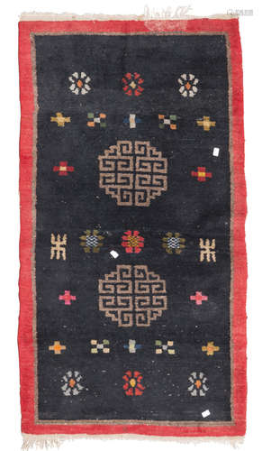 TIBETAN CARPET, EARLY 20TH CENTURY double meander medallion and secondary motifs of rosettes and