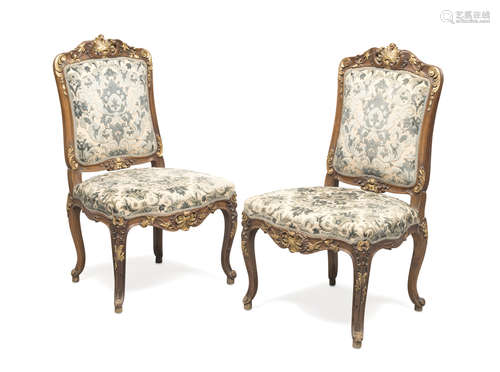 A PAIR OF WALNUT CHAIRS, PERIOD NAPOLEON III entirely sculpted to leaves and vegetal motifs, with