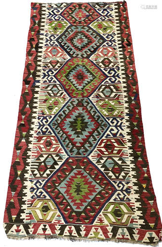 A Turkish kelim, with five linked polychrome hooked medallions, 300 x 147cm.