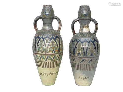 A large pair of Moroccan pottery twin handled vases, each with Islamic script,