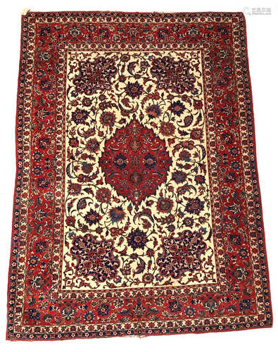 A Esfahan rug, West Persia, the ivory field with a central madder medallion with palmettes,