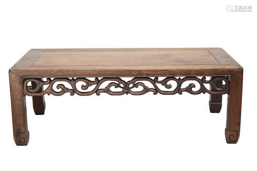 A Chinese hardwood Kang table, circa 1900, with a foliate carved frieze,