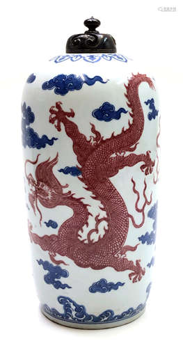 A Chinese porcelain vase and cover, Qianlong mark, with two red dragons amidst cloud scrolls,