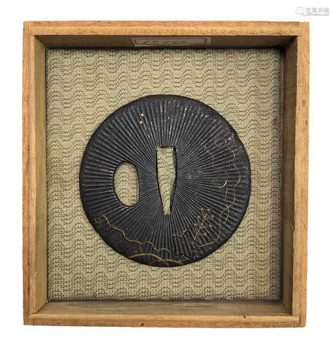 A Japanese gilt metal decorated tsuba, diameter 7cm, with wooden box.