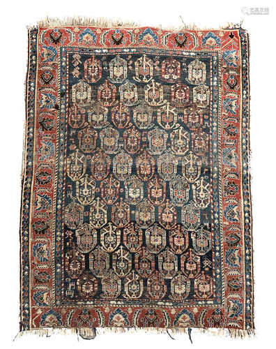 An Afshar rug, South West Persia, the indigo field with rows of polychrome boteh, animals and guls,