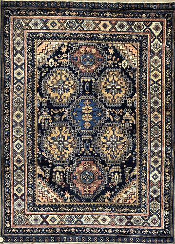 A Chinese rug, the indigo field with seven stepped polychrome medallions,