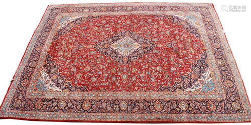 A Meshad carpet, South East Persia, the madder field with a polychrome lobed pole medallion,