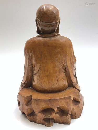 A Chinese carved wood figure of a seated buddha, height 36cm, width
24cm, depth 16.5cm.