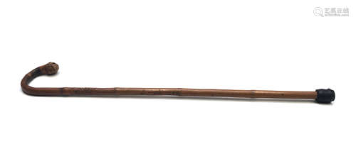 A Japanese bamboo walking stick, with root knop and carved with figures to the shaft, signed,