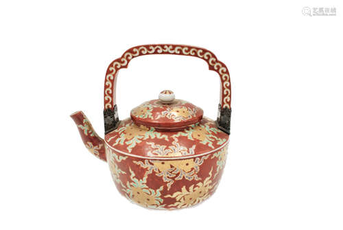 A Japanese red porcelain tea kettle, 19th century, the handle with pierced white metal mounts,