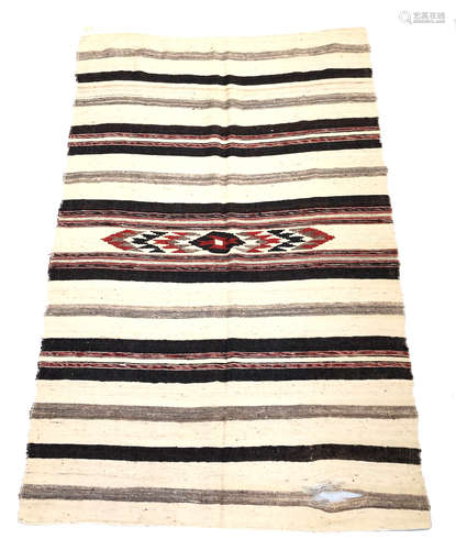 A Moroccan Berber kelim, with horizontal bands and serrated guls to the centre, 214 x 140cm.