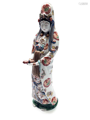 A Japanese porcelain figure of Guanyin, Meiji period, standing holding a scroll,