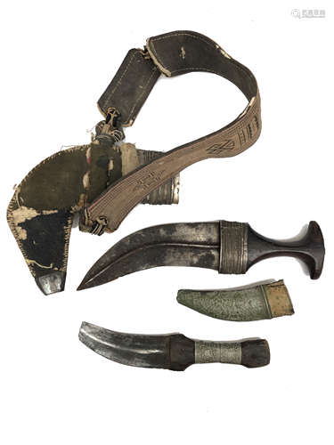 An Eastern Kukri, in part white metal scabbard, length 34cm and another smaller, length 26cm.