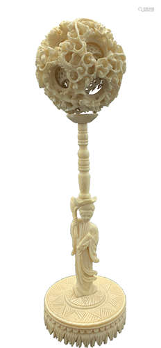 A Chinese ivory puzzle ball and stand, circa 1900, diameter 5.5cm, height of stand 15.5cm.