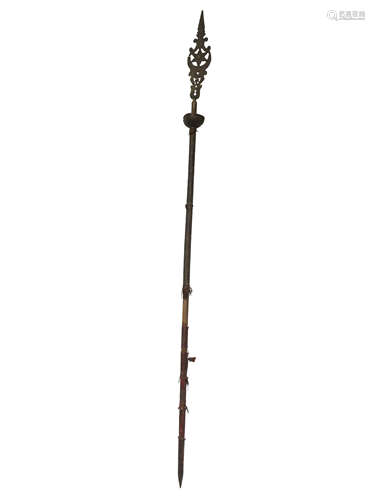 An Islamic gilt metal ceremonial standard, circa 1900, the wooden pole part covered in brass,