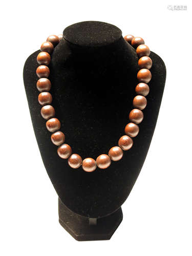 A plain spherical pine bead necklace.