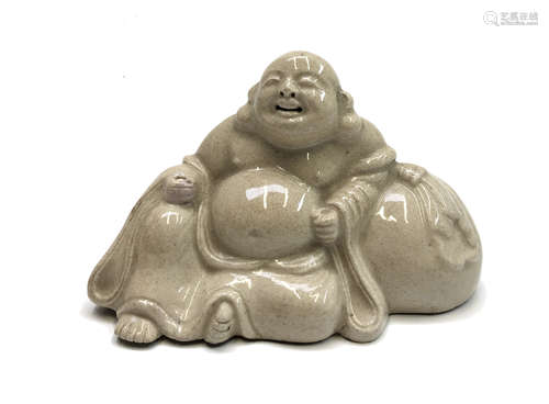 A Chinese pottery figure of Hotei, the laughing buddha, signed, height 10.5cm, width 16cm.