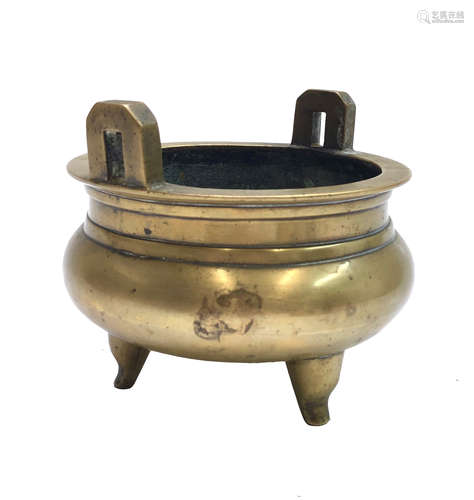 A Chinese polished bronze censer, 19th century, the pair of handles flanking a bulbous body, Xuande,