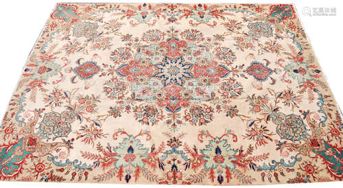 A Tabriz carpet, North West Persia, the ivory field with a large polychrome pole medallion,