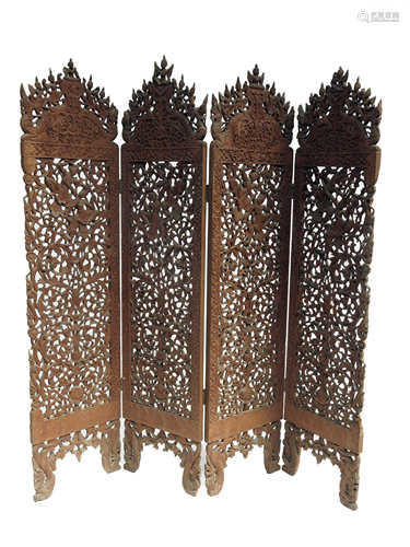 A Burmese hardwood four fold screen, late 19th century,