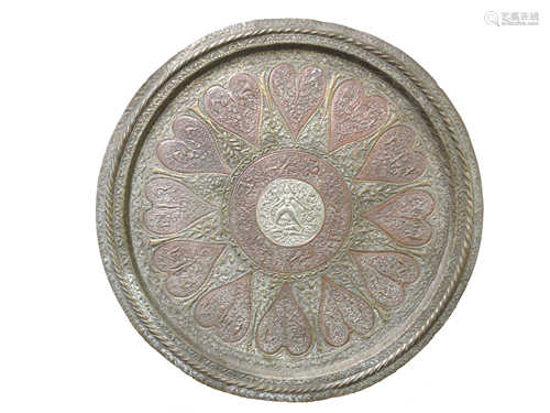 An Indian brass and copper circular tray, with central white metal roundel, diameter 60.