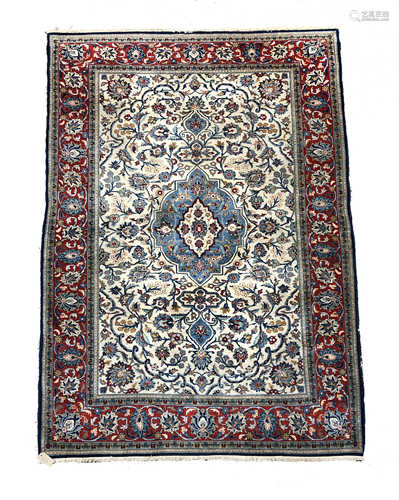 A Ghom rug, Central Persia, the ivory field with a central pale blue lobed pole medallion,