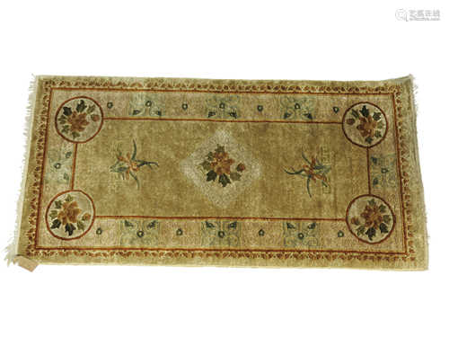 A Chinese silk rug, with a floral central medallion,