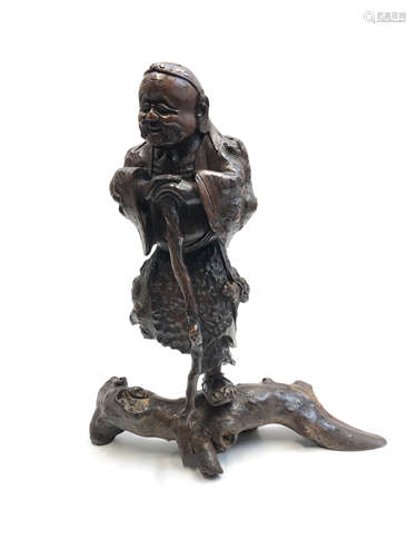 A Chinese rootwood carved figure on stand, the man leaning on a staff, height 51cm,