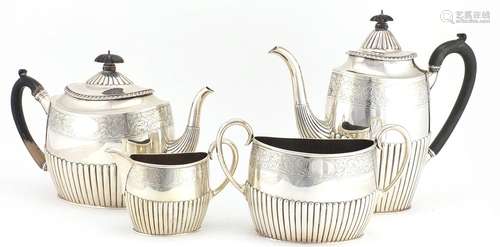 Victorian silver four piece tea set with demi fluted body and engraved with flowers, by Walter &