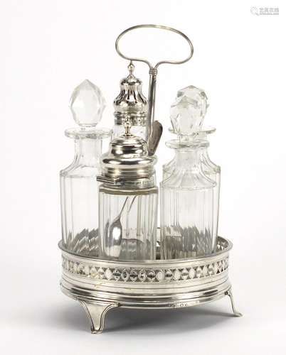 Georgian silver five bottle cruet stand with five glass bottles, two with silver lids, the stand