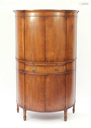 Inlaid walnut bow fronted cocktail cabinet, fitted with a pair of doors above a mixing shelf with