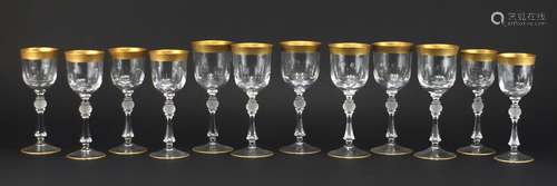 Two sets of six gilded crystal goblets in the stlye of Moser with gilt foliate bands, the largest