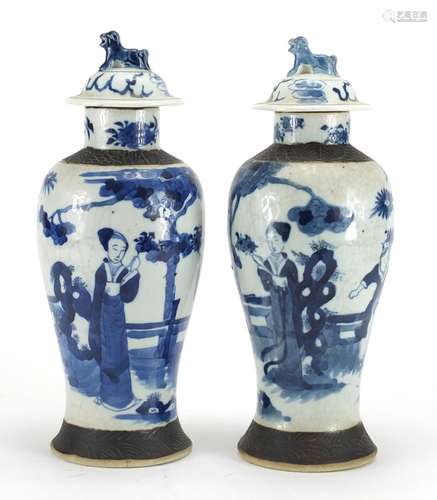 Pair of Chinese blue and white crackle glazed baluster vases and covers, hand painted with