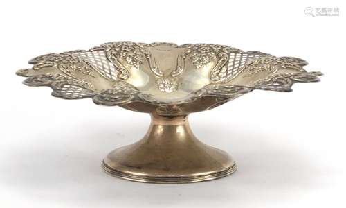 Circular silver pedestal dish pierced and embossed with flowers and berries, by Harrison Fisher