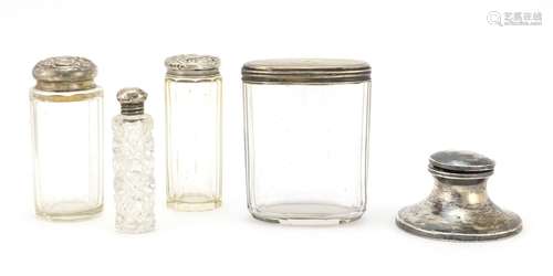 Four cut glass jars and bottles with silver lids and a silver inkwell, various hallmarks, the