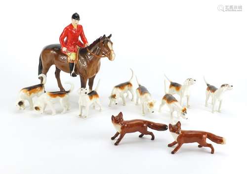 Beswick huntsmen on horseback with eight hounds and two foxes, the largest 21cm high : For Further