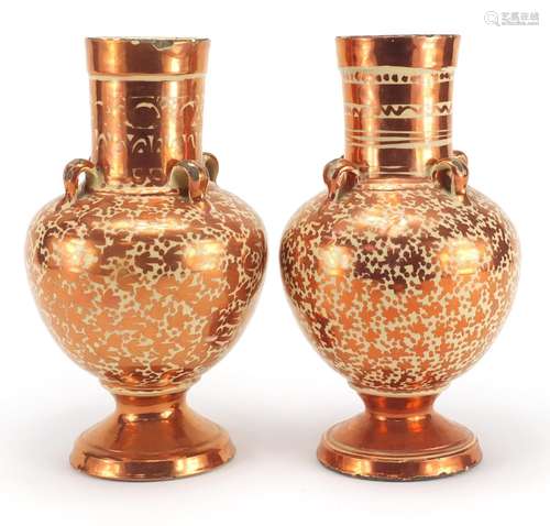 Pair of Middle Eastern lustre vases with four handles, each decorated with floral motifs, each