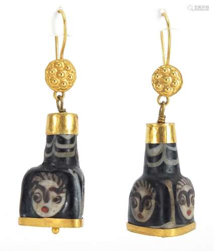 Pair of Islamic unmarked gold mounted glass earrings, hand painted with face masks, 5cm in length,