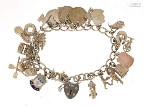 Silver charm bracelet with a selection of mostly silver charms including Singer sewing machine,