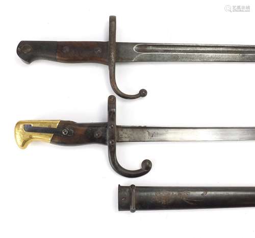 Two military interest bayonets including a French example with scabbard, various impressed marks,