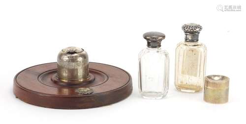 Silver items comprising inkwell on mahogany base, two cut glass scent bottles and a cylindrical